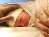 A few minutes old! (Thumbnail 31.1 k bytes, click through to 436kB file).  Taken by Dr Smith, the anaesthetist, doing double duty recording the birth.  Great photographer, even better anaesthetist.  Since Jeffrey was born by C-section, that was key.  At this point the boy is about 15 minutes old, he's already been weighed (6lb 4oz) and had his vital signs checked.  He's even wearing his first nappy (diaper)... - Welcome to America, kid!