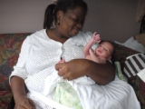 Playing with Mummy (Thumbnail 28 k bytes, click through to 382kB file).  He's about two weeks old in this picture.